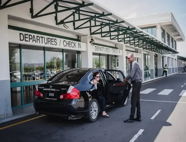 Big C airport pickup beside a black car at the terminal